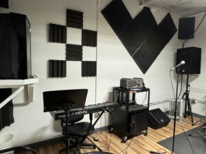 A soundproof music studio with equipment and microphones at BQE Studios